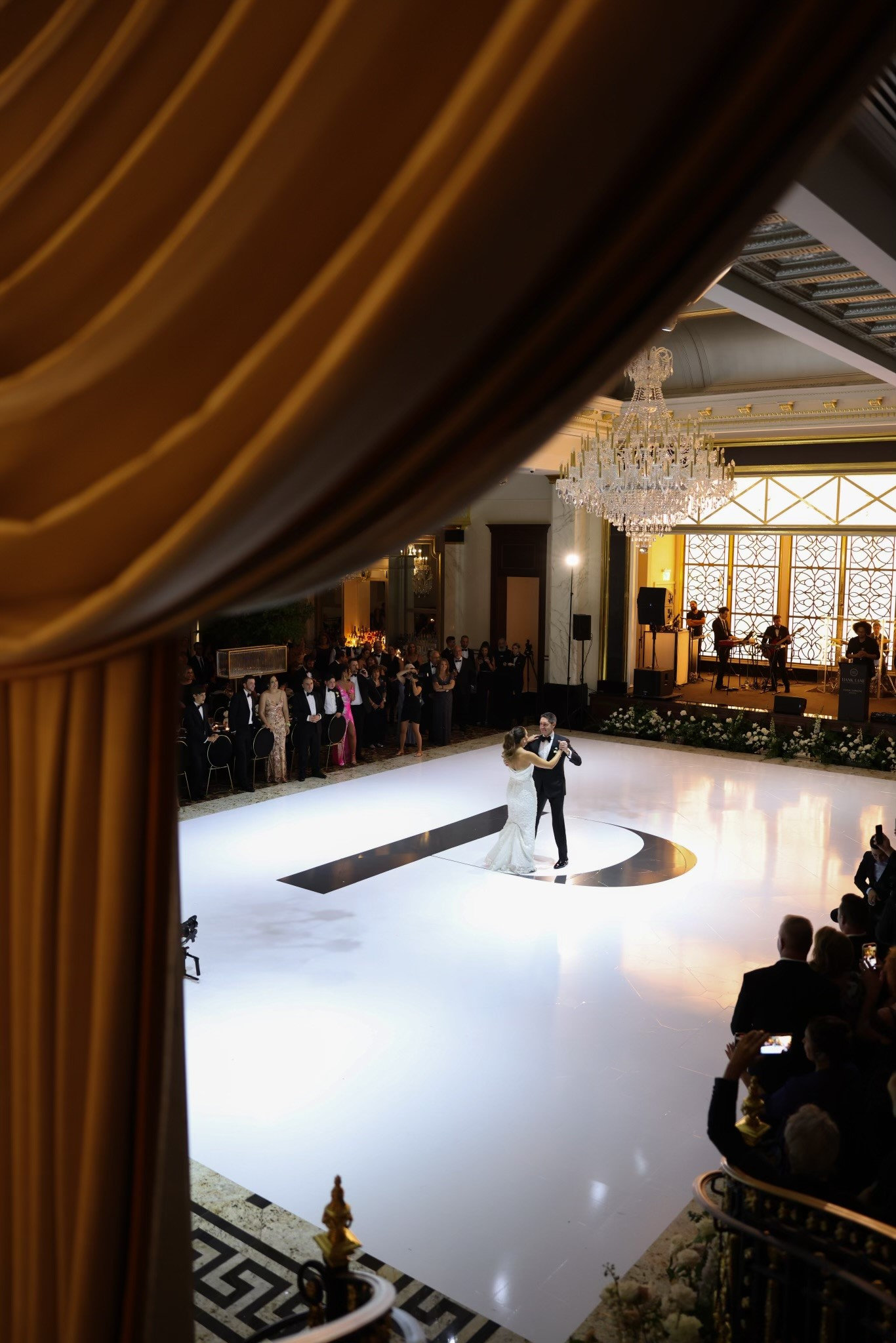 A view of the dance floor through gold drapery