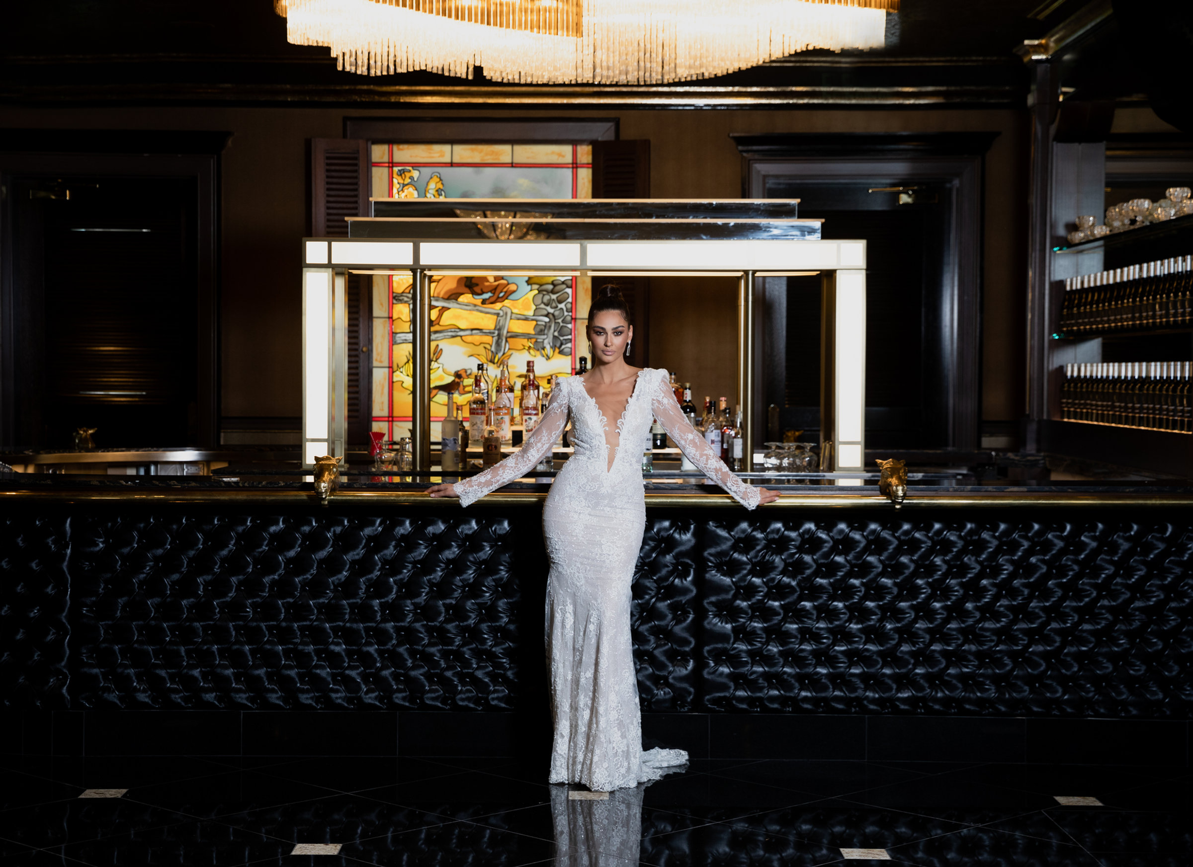 A bride at the tufted black bar
