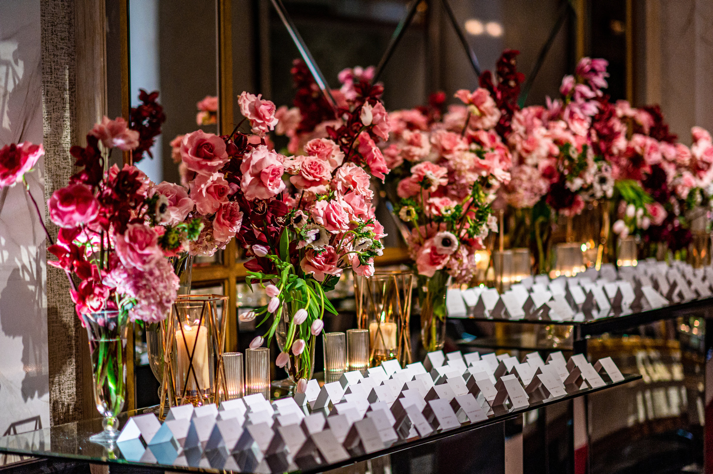 Escort cards set among pink roses