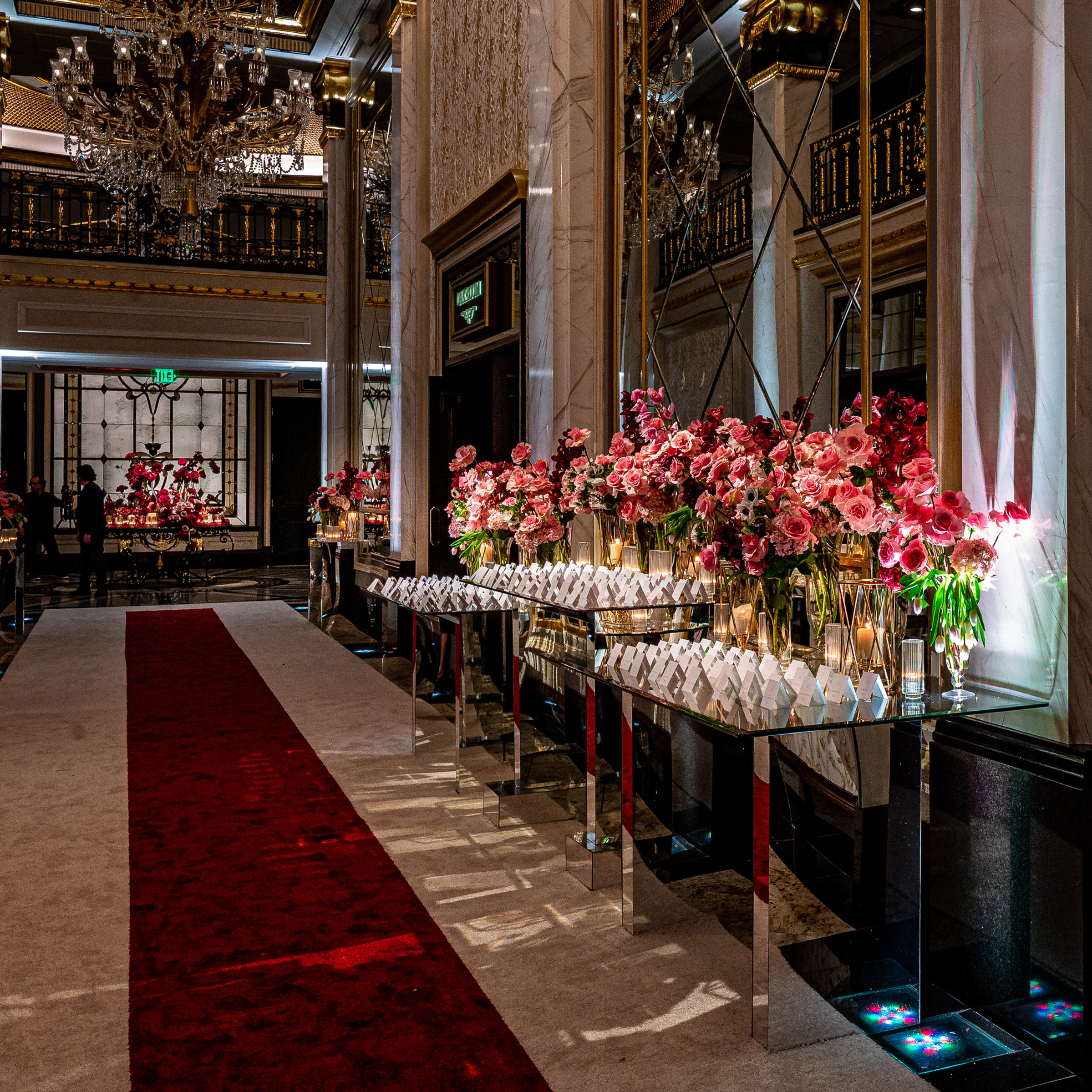 A red-carpet escort display lined with florals