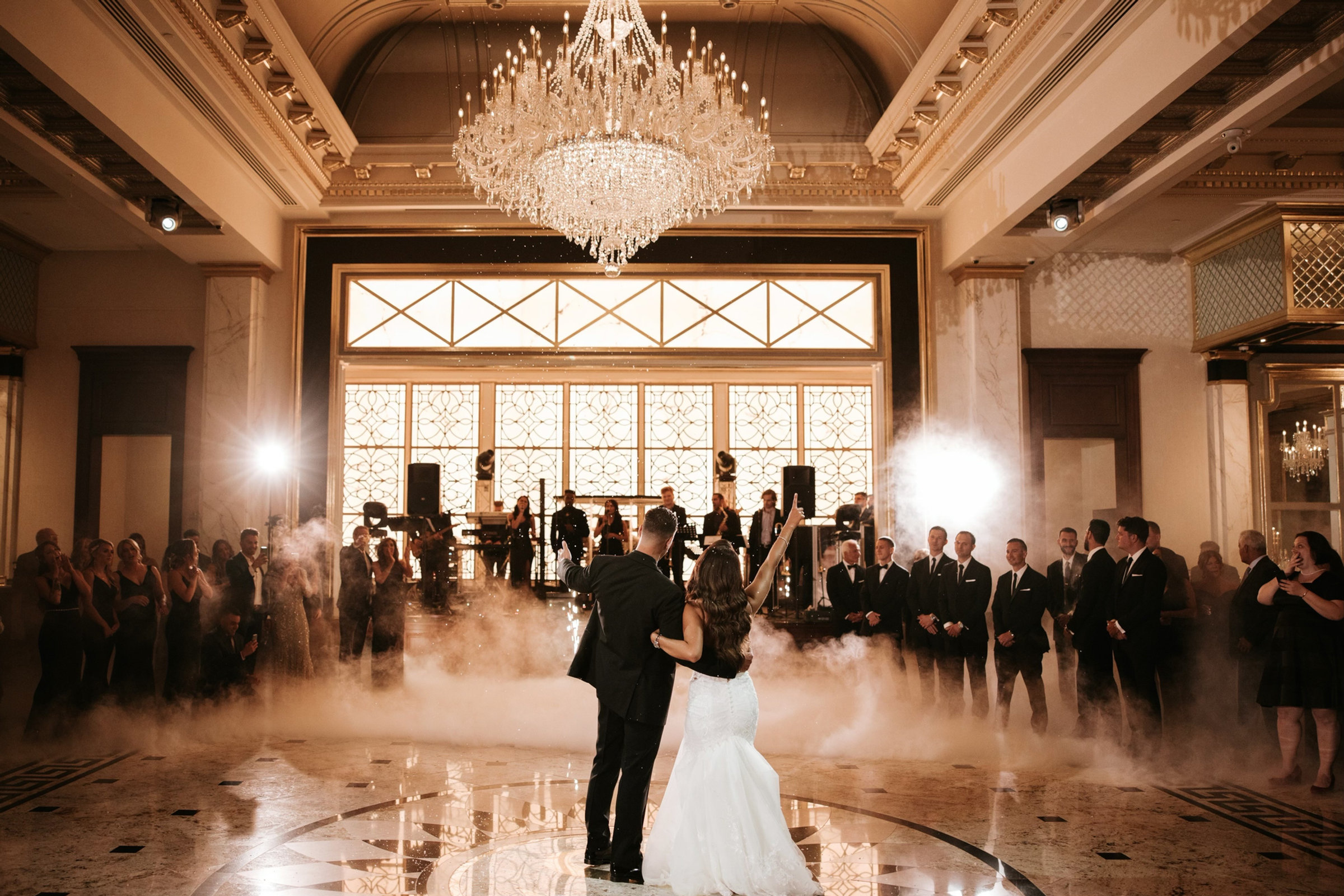 A first dance under crystal chandeliers in the ballroom