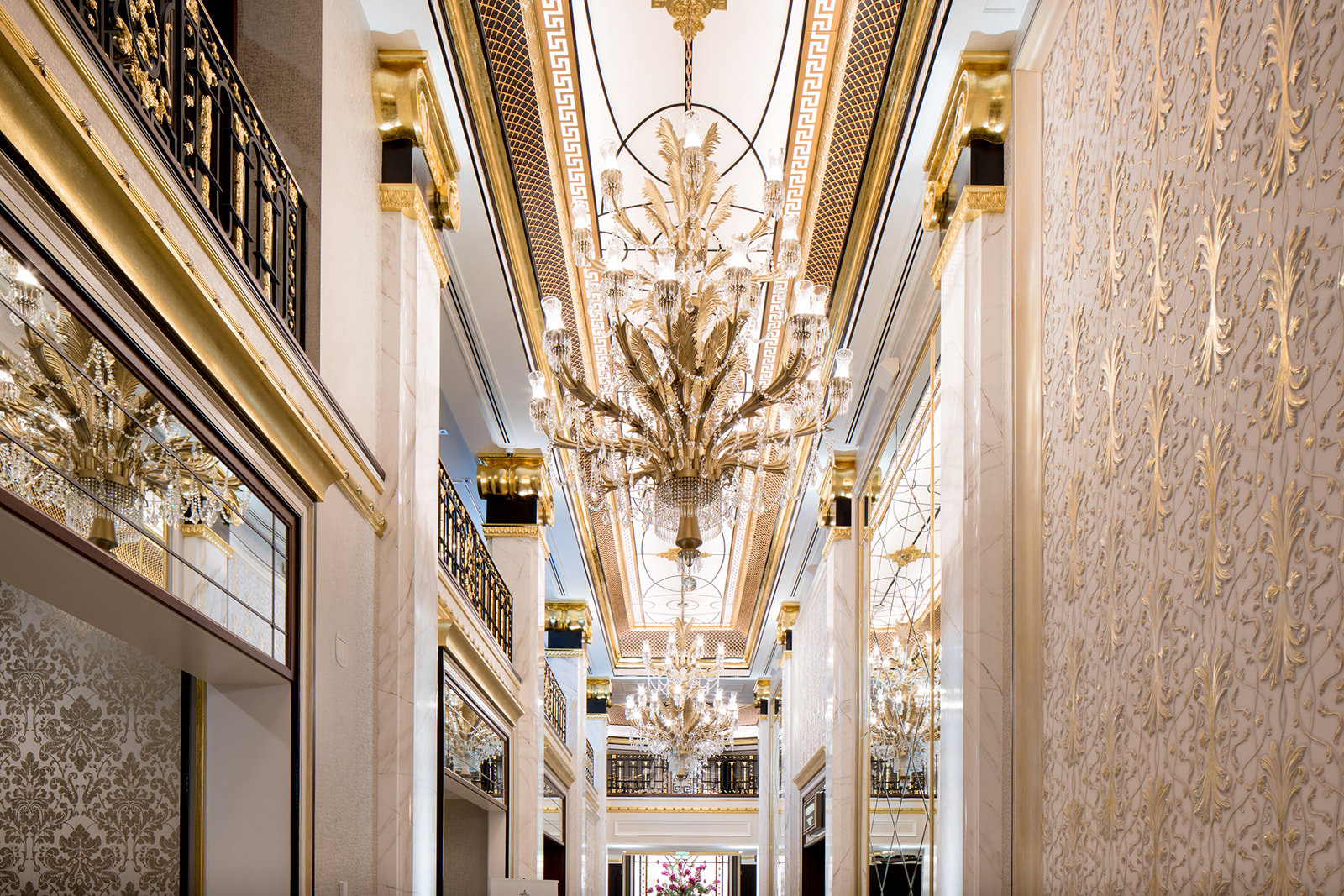A gilded gallery lined with crystal chandeliers