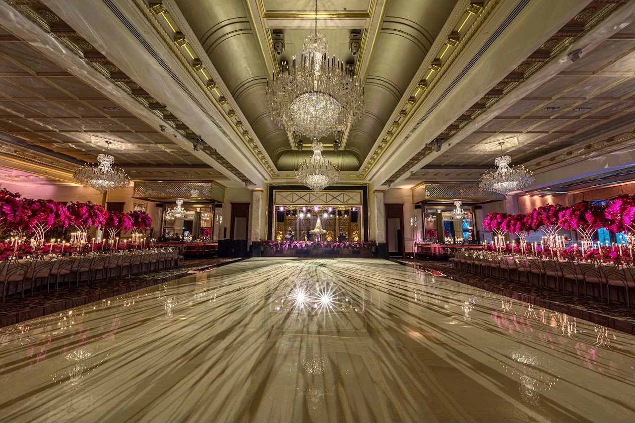 The ballroom with floral centrepieces and mirrored floor