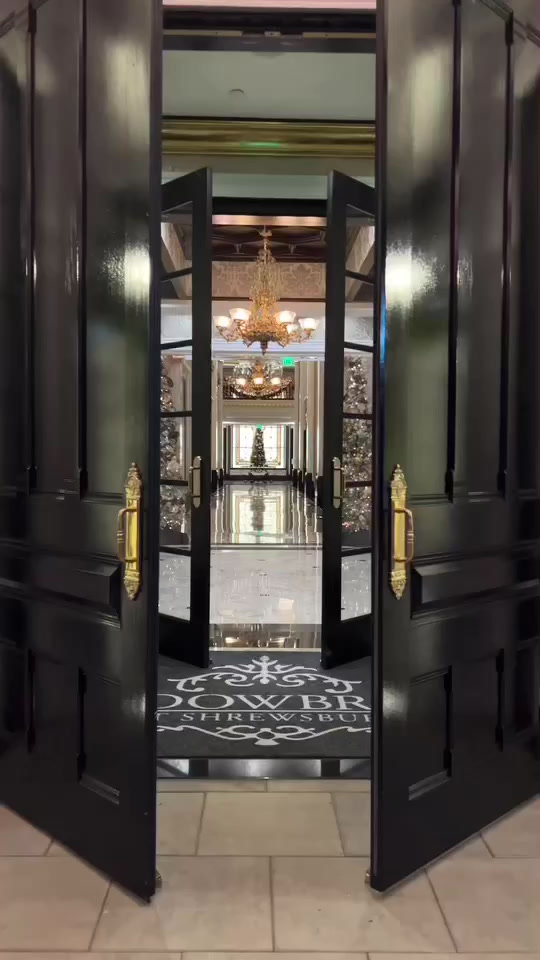 Tall black doors opening onto the foyer