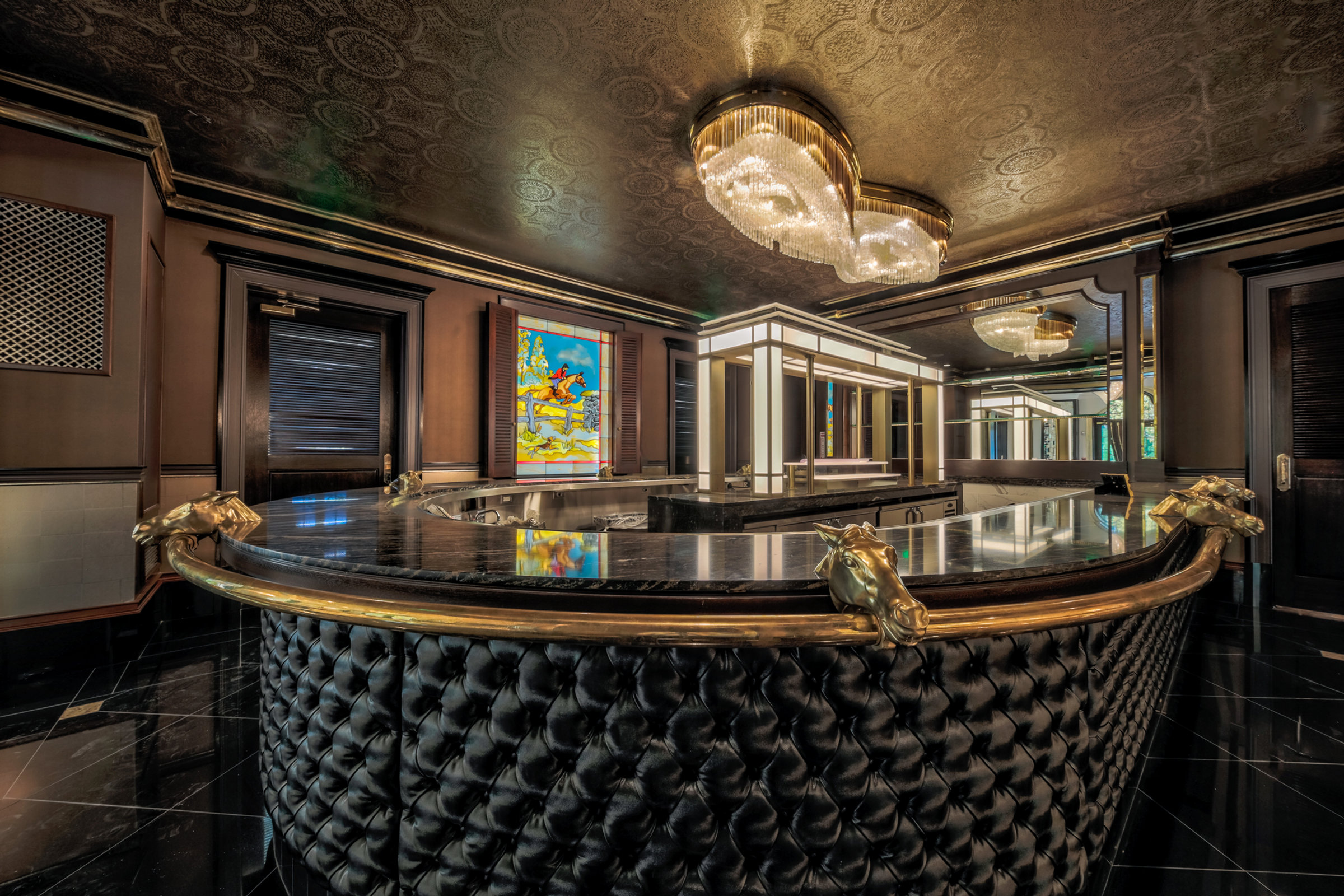 The curved horseshoe bar with brass rail